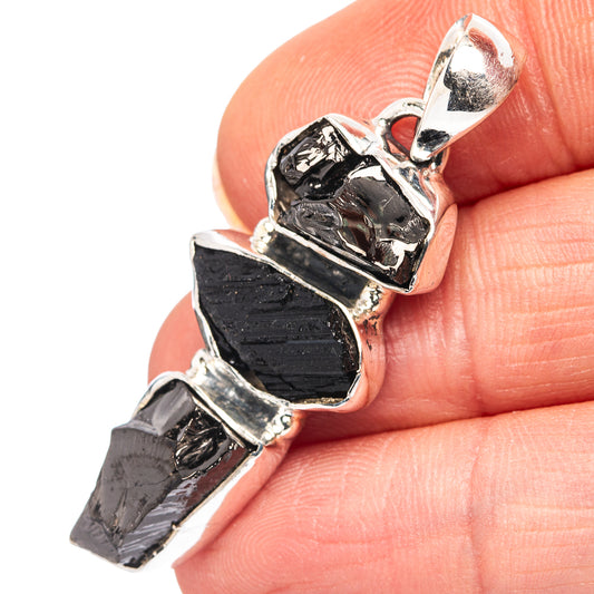 Close-up shungite tektite pendant: dark stone facets in .925 sterling silver setting