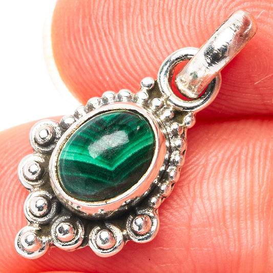 Oval malachite cabochon sterling silver pendant with ornate beaded frame and loop bail