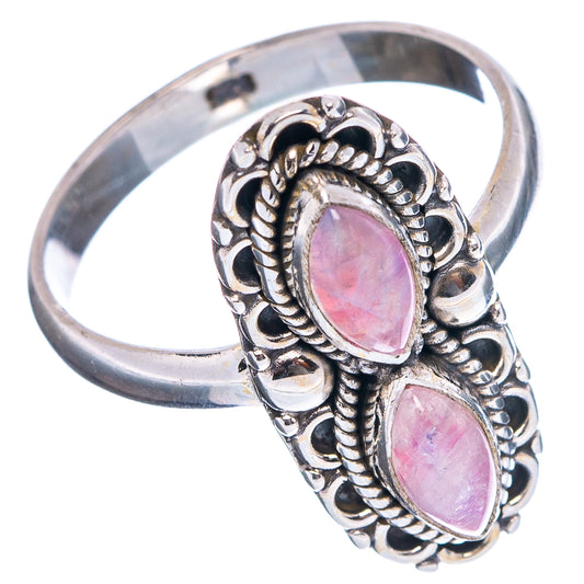 Silver cocktail ring with two pink oval stones, detailed filigree and open band