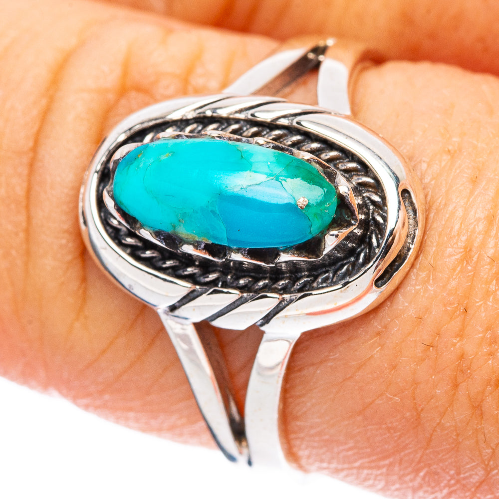 Oval turquoise cabochon sterling silver ring with decorative rope-style bezel