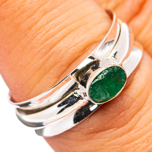 Sterling silver spinner ring with oval green gemstone bezel and textured black detailing