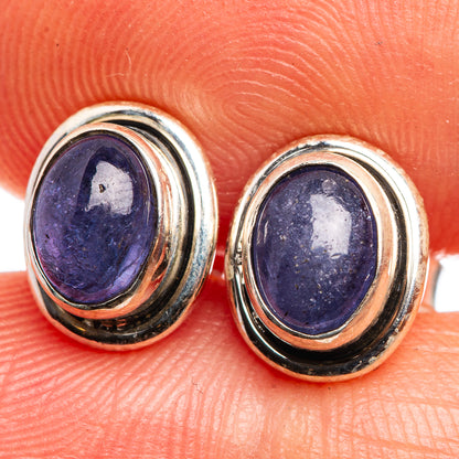 Close-up oval tanzanite stud earrings in 925 sterling silver bezel