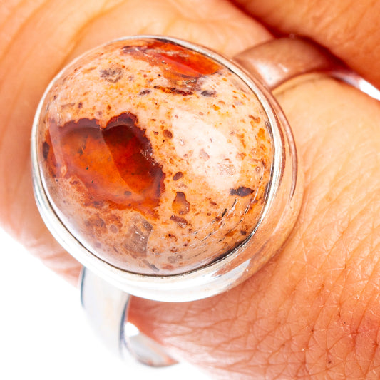 Sterling silver ring with oval fire opal cabochon, warm orange-red and speckled stone