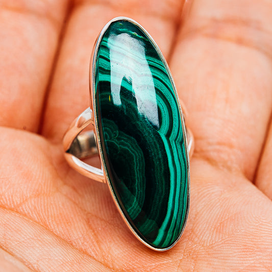 Oval malachite cabochon ring with green striped stone and silver bezel