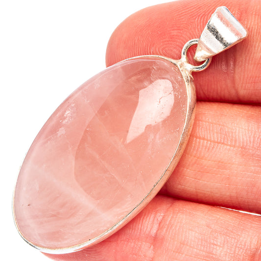 Rose quartz pendant with oval pink gemstone and silver-plated bail, close-up