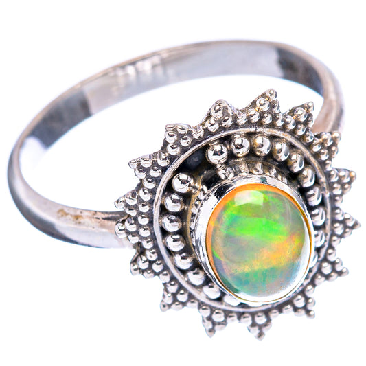 Sterling silver opal ring with oval green-orange opal in raised round bezel and spiky edge.