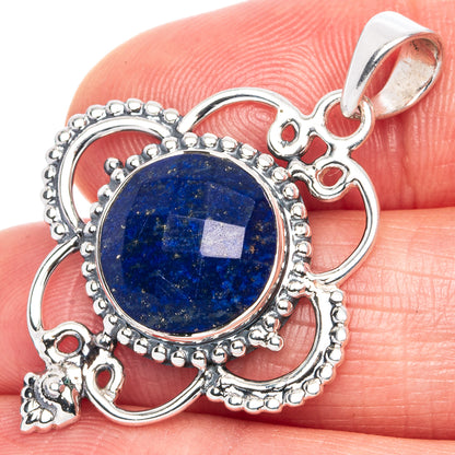 Sterling silver lapis lazuli pendant with oval blue cabochon and red stone details