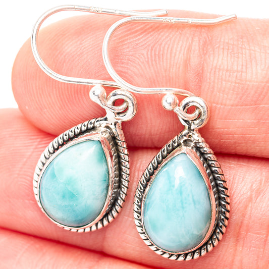 Close-up of larimar teardrop earrings with ornate .925 sterling silver bezel and hooks