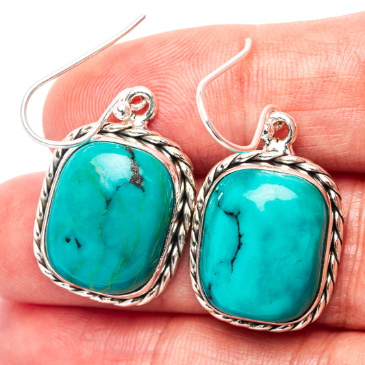 Sterling silver turquoise drop earrings with oval cabochon and rope-edge setting
