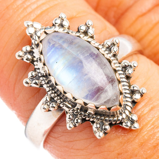 Sterling silver moonstone ring with oval light-blue cabochon and ornate floral prongs