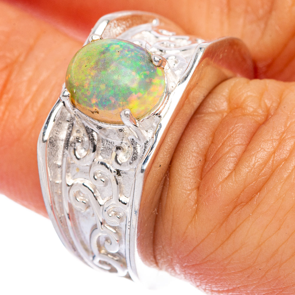 Sterling silver opal ring, green-orange cabochon on carved bezel