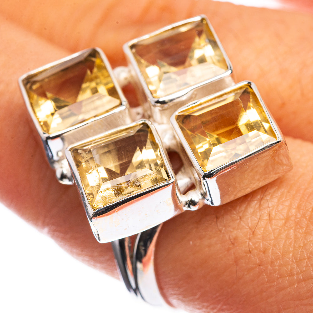 Sterling silver ring with four large faceted citrine squares, polished band.