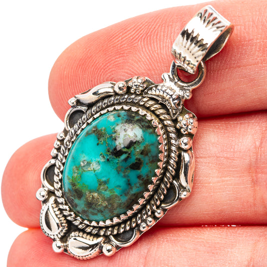 Turquoise oval pendant with ornate sterling silver frame and scalloped border