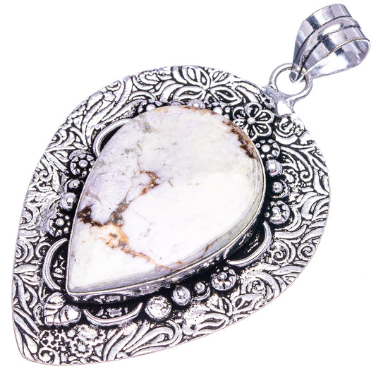Silver-tone teardrop pendant with white and brown stone, decorative engraved frame