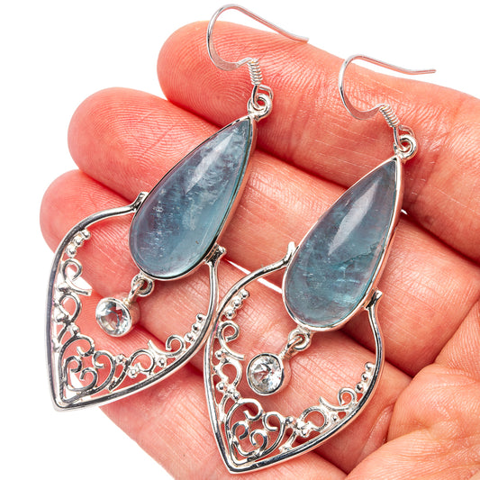 Silver filigree teardrop earrings with blue topaz accents and round gemstone drops