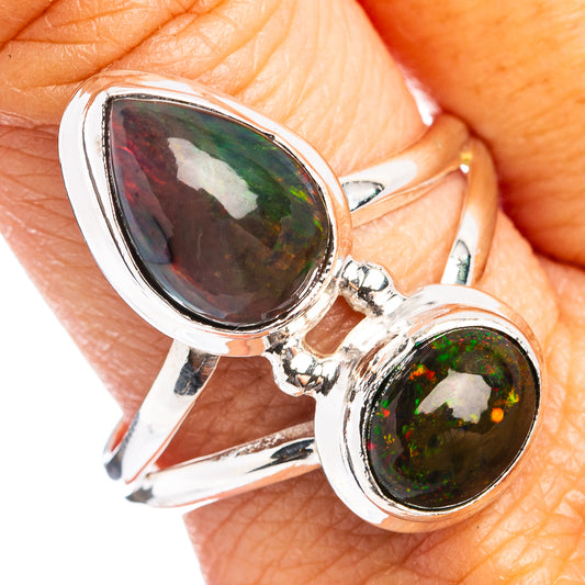Sterling silver ring with two teardrop black opal gemstones, green and dark flashes.
