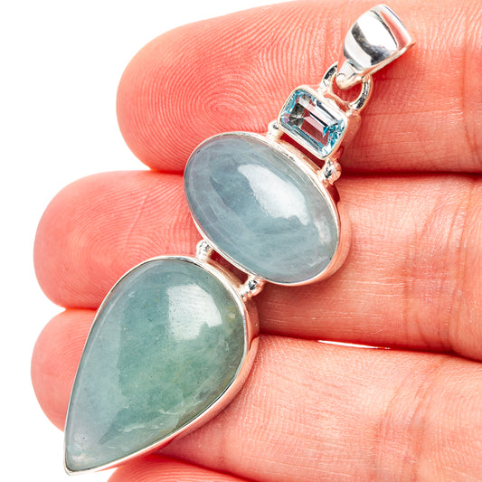 Sterling silver pendant with two light-blue teardrop gemstones and square topaz bezel