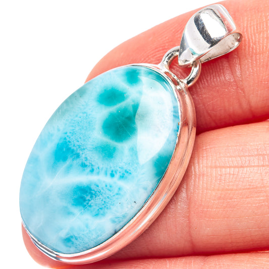 Oval larimar pendant with .925 sterling silver bezel and bail, bright blue stone detail.