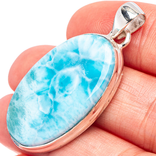 Larimar pendant close-up with bright blue marbled pear stone in silver setting