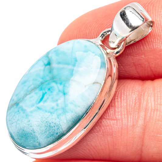 Larimar pendant close-up: oval blue stone in silver bezel with top bail
