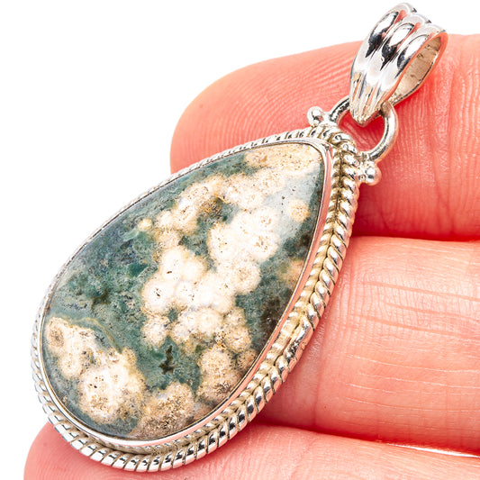 Ocean jasper teardrop pendant in .925 sterling silver, textured border and bail.