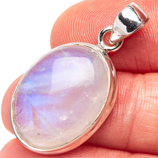 Rainbow moonstone oval pendant with silver bezel and hinged top bail, close-up on stone