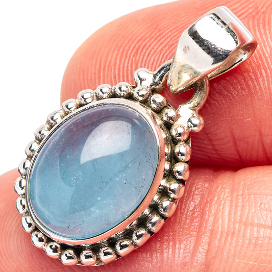 Oval aquamarine pendant in .925 sterling silver, beaded halo and open bail