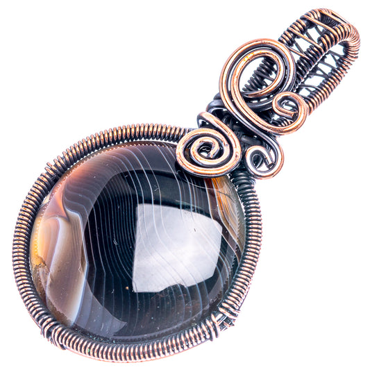 Oxidized copper wire-wrap pendant with oval banded black agate, spiral accents and loops