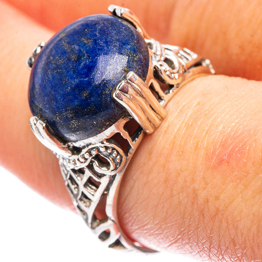 Sterling silver ring with oval blue lapis stone and ornate filigree openwork band