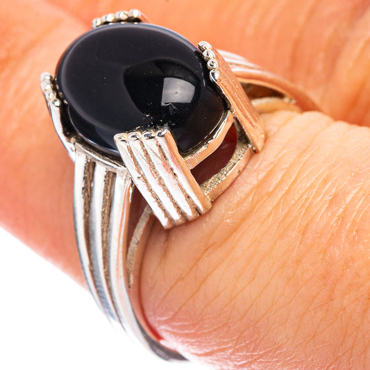 Oval black onyx-style cabochon sterling silver ring with filigree side accents
