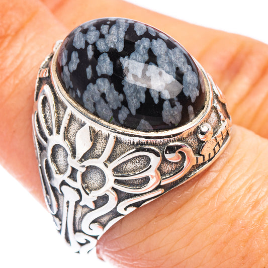 Sterling silver filigree ring with dark oval stone and snowflake patterns