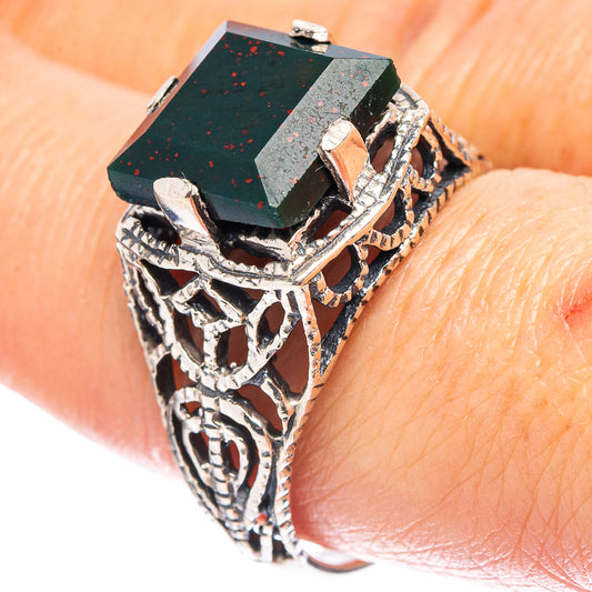 Sterling silver filigree ring with dark green rectangular gemstone, ornate side details