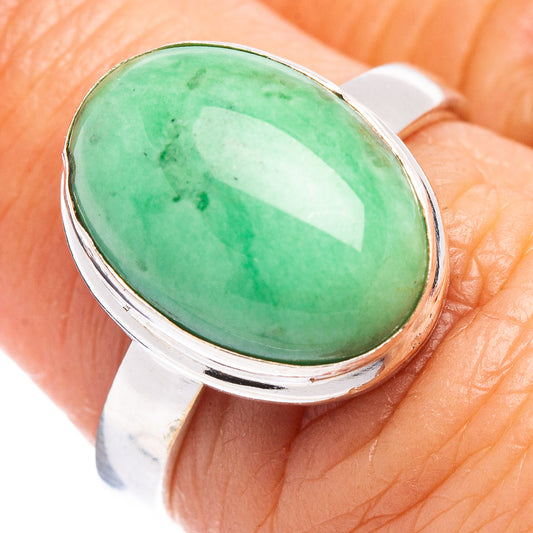 Sterling silver ring with oval green cabochon gemstone, close-up top view
