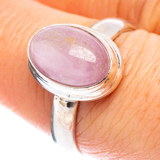Sterling silver oval gemstone ring on finger, pink cabochon in raised bezel