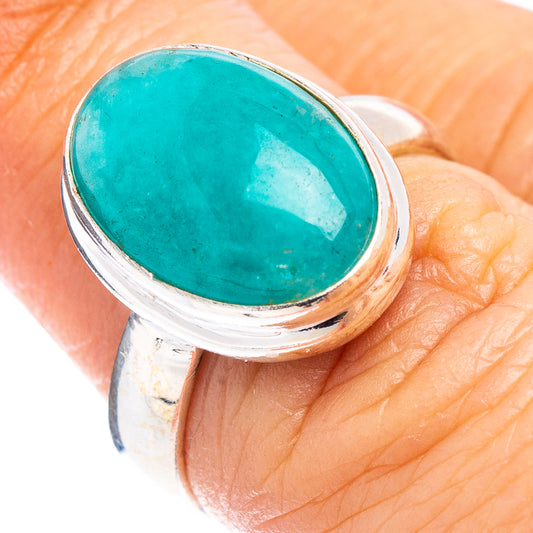 Turquoise oval gemstone sterling silver ring with domed bezel, worn on finger