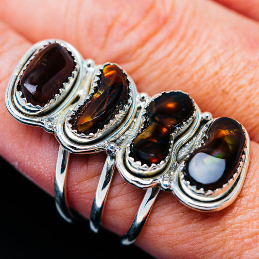 Sterling silver ring with four oval fire agate cabochons, dark brown and multicolor glow