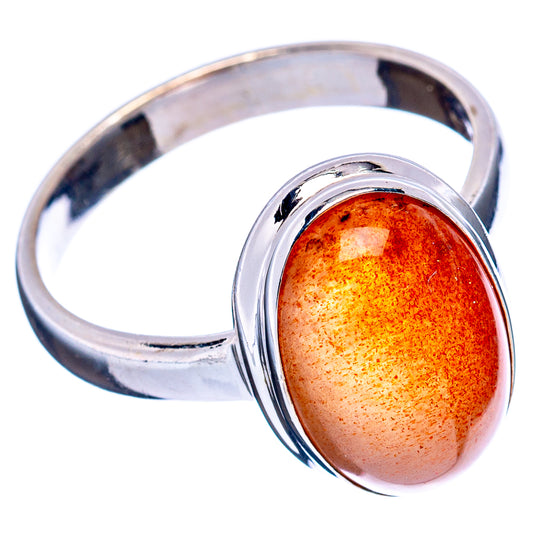 Sterling silver ring with oval orange sunstone cabochon, reflective polished band