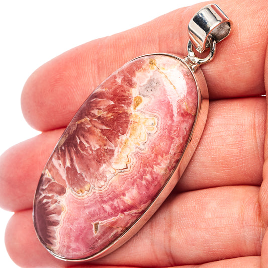 Oval rhodochrosite pendant with pink-red stone and .925 sterling silver bezel