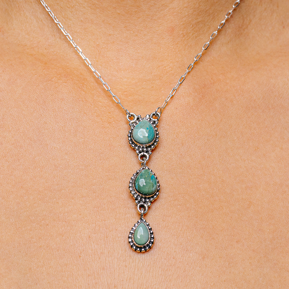 Sterling silver turquoise pendant necklace with three oval cabochons and ornate prong settings