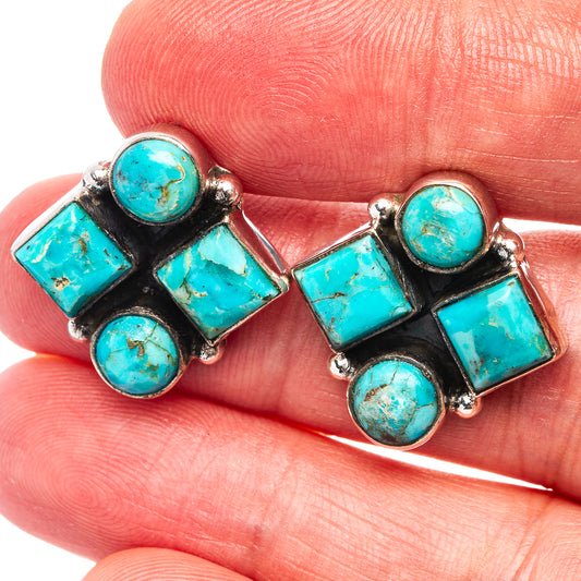 Turquoise gemstone stud earrings with black settings and silver bezels