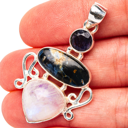 Sterling silver pendant with dark blue oval stone, round purple stone, and pale teardrop