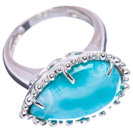 Sterling silver larimar ring showing oval light-blue stone, prong and beaded details.
