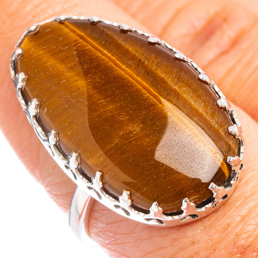 Close-up of oval tiger's eye stone ring with .925 sterling silver scalloped prongs
