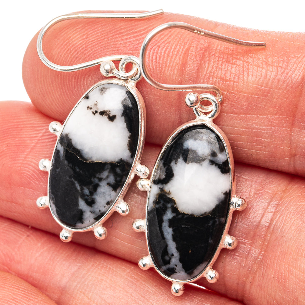 Oval sterling silver drop earrings with black and white stone, beaded halo setting