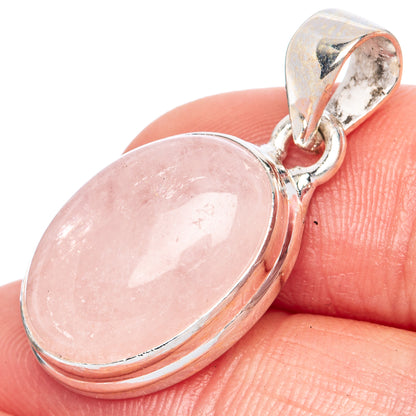Oval pink gemstone pendant in sterling silver, with hinged bail detail