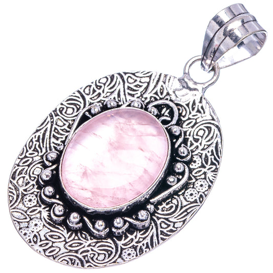 Rose quartz pendant with oval pink cabochon, decorative German-silver style frame