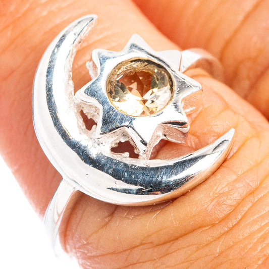 Sterling silver crescent-moon ring with round amber gemstone in open star setting