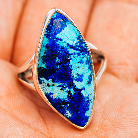 Sterling silver oval ring with bright blue stone, angled view on hand