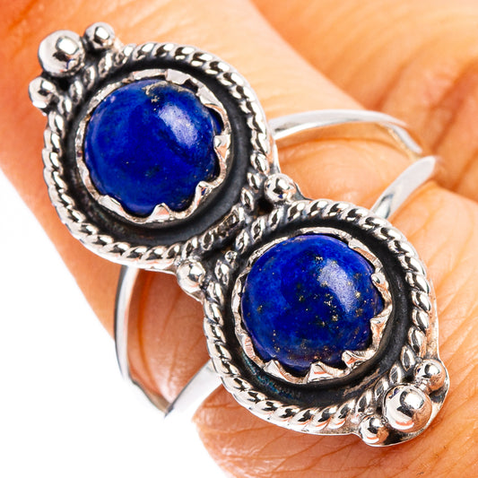 Sterling silver lapis lazuli ring on hand, two dark blue oval stones in raised halos