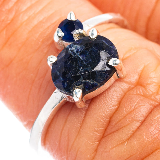 Sterling silver ring with oval blue gemstone and four-prong bezel